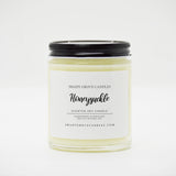 straight sided glass jar candle with black twist off metal lid and white label