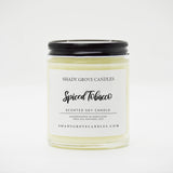 straight sided glass jar candle with black twist off metal lid and white label