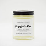 straight sided glass jar candle with black twist off metal lid and white label