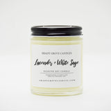 straight sided glass jar candle with black twist off metal lid and white label