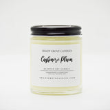 straight sided glass jar candle with black twist off metal lid and white label