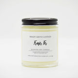 straight sided glass jar candle with black twist off metal lid and white label